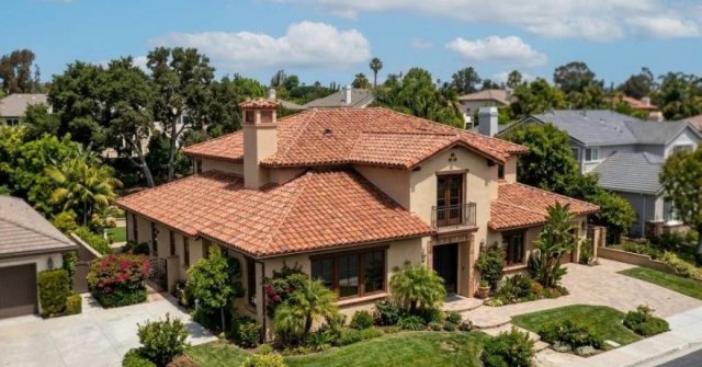Homeowner documenting damaged roof tiles
