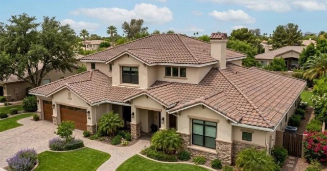 Homeowner documenting damaged roof tiles